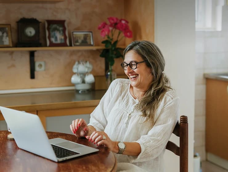 A woman working on a laptop at home