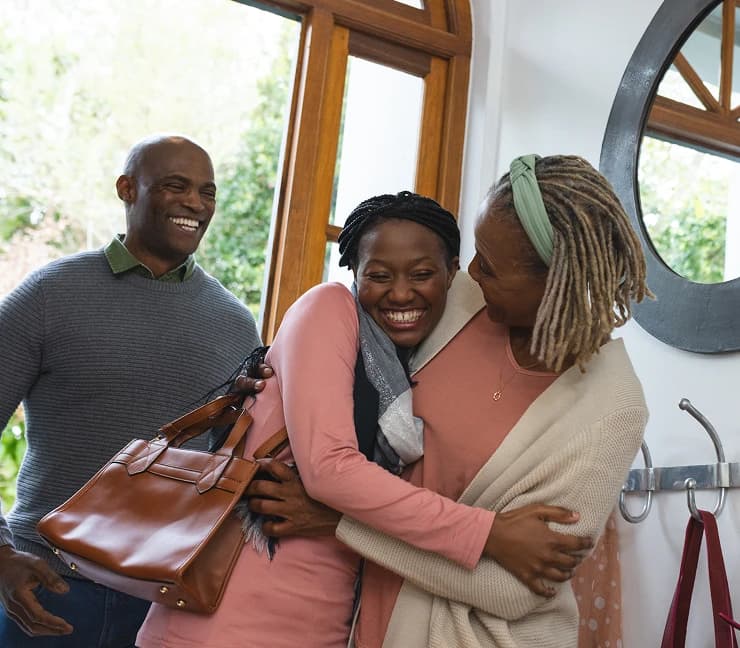 People greeting each other at a front door