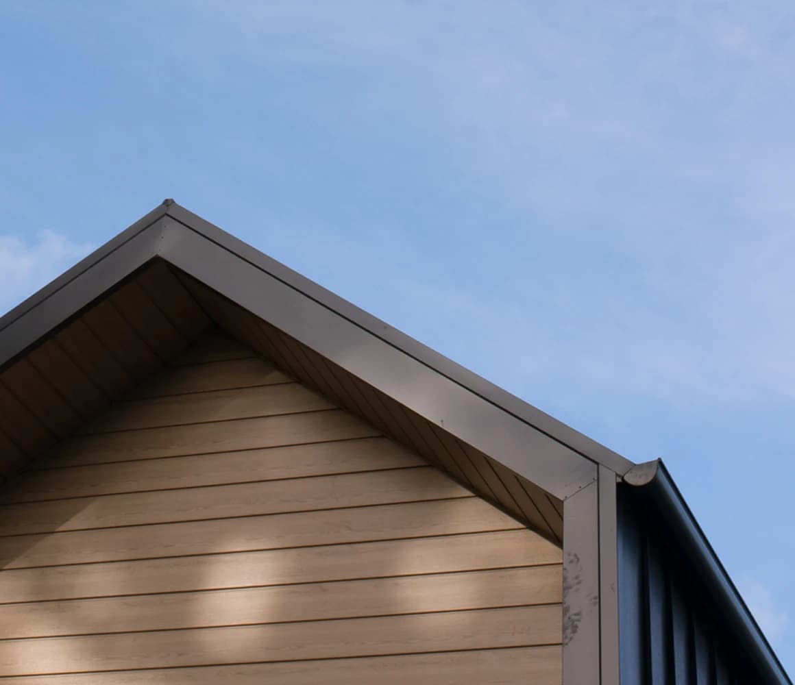 A house roof beneath a blue sky